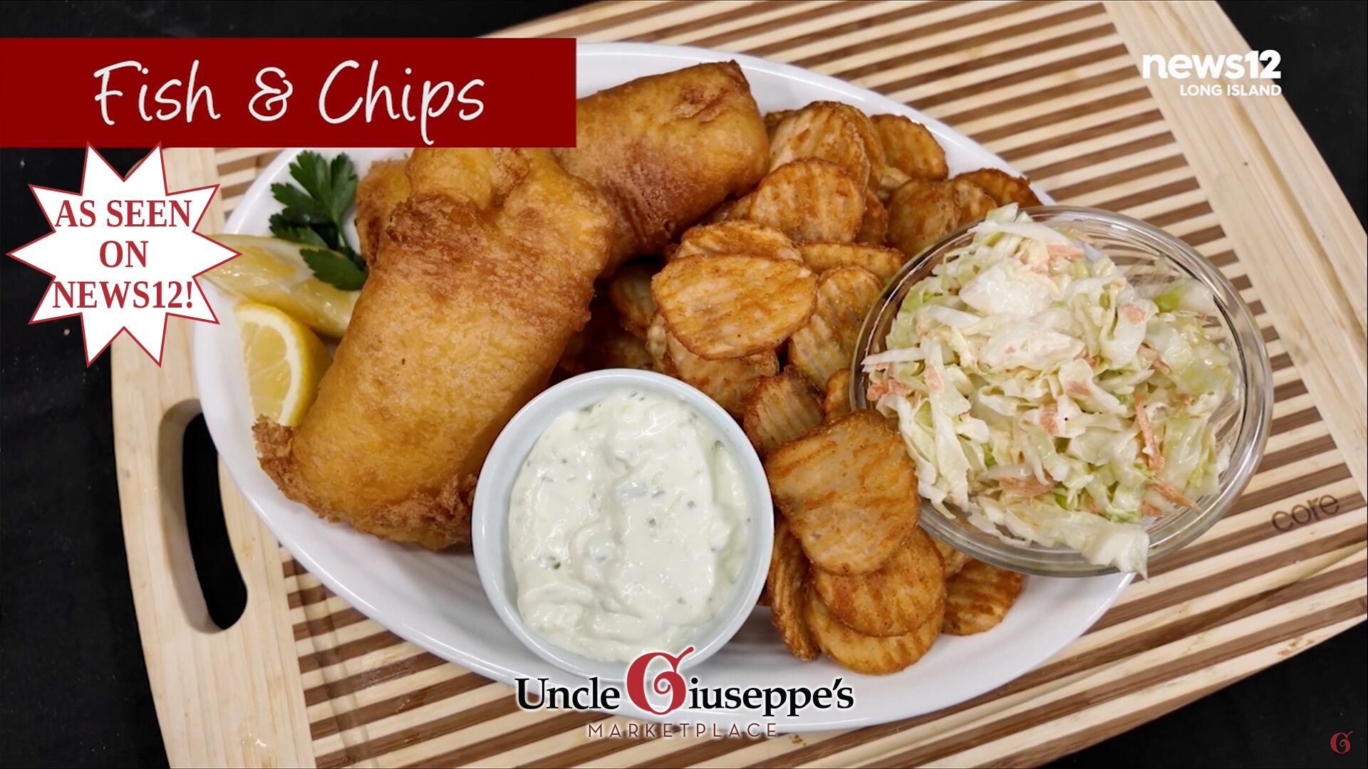 Fish and chips on a white plate set on a striped cutting board.