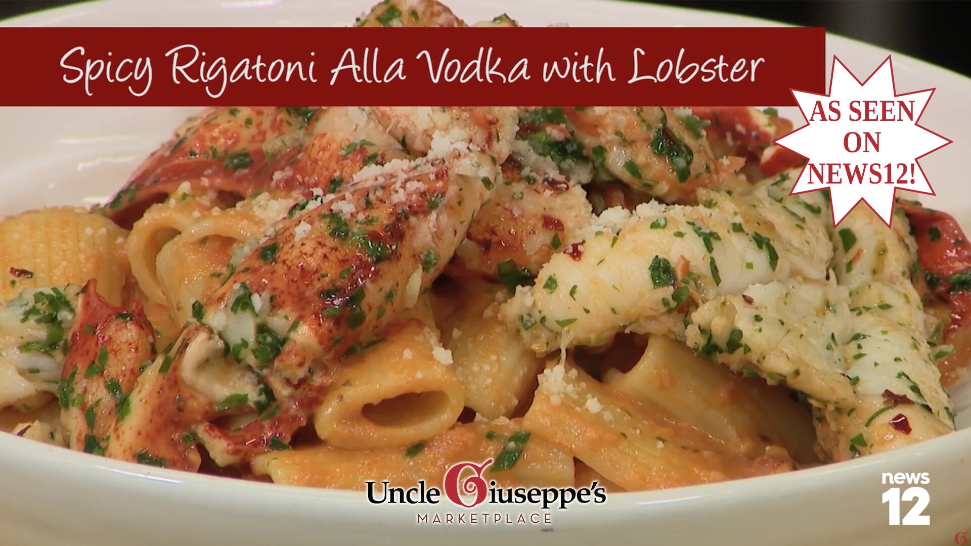 Rigatoni pasta in sauce topped with chunks of lobster