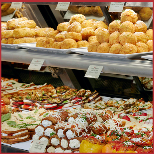 Uncle Giuseppe's deli case items with rice balls and eggplant rollatini