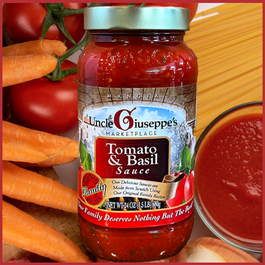 Uncle Giuseppe's jarred tomato sauce with carrots and tomato in the background