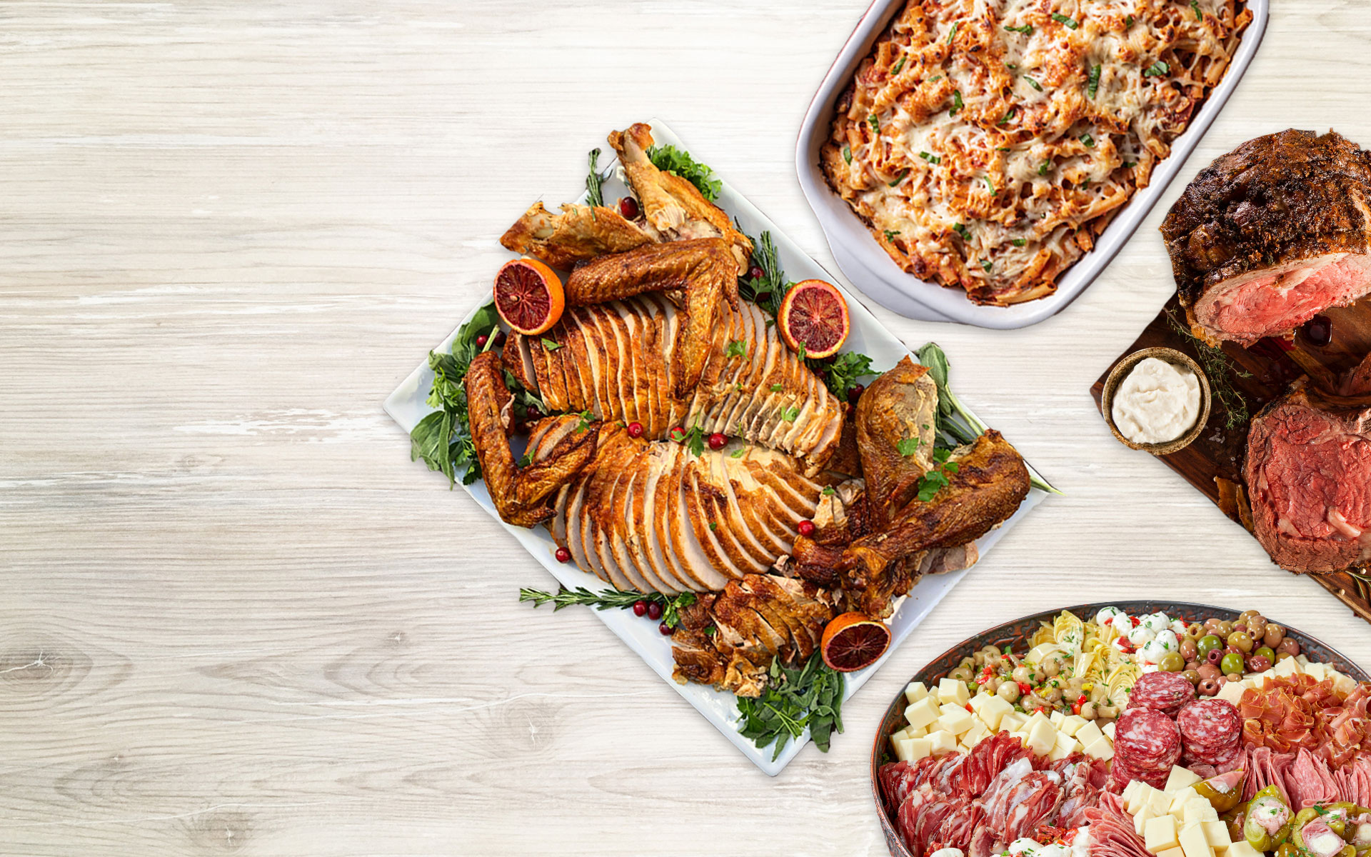 Flat lay of a carved turkey, baked ziti, antipasto and roast